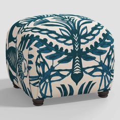 a blue and white ottoman sitting on top of a floor