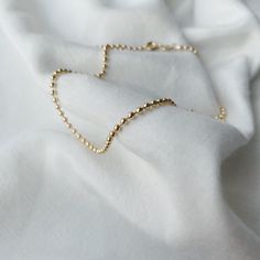 Elevate your jewelry game with the 18K Gold Filled Ball Chain—a simple piece designed to add just the right amount of shine to any look. Perfect for layering or wearing on its own, this chain brings a minimalist touch to your everyday style. The Details: -18k Gold Filled: Offers the luxurious look of solid gold at a fraction of the price, with lasting durability and shine.- 2.3mm Ball Chain Design: Features smooth, round gold balls that add texture and sophistication, catching the light with eve Necklaces Simple, Unique Pendant Necklace, Ball Chain Necklace, D F, Jewelry Essentials, Gold Filled Ring, Unique Pendant, Ball Chain, Sales Gifts