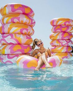 a woman sitting on top of an inflatable float