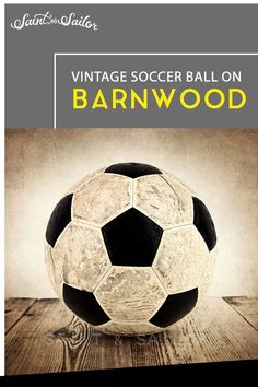 an old fashioned soccer ball on top of a wooden table with the title vintage soccer ball on barnwood