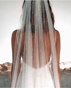 the back of a woman wearing a wedding veil