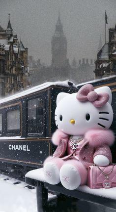 a hello kitty sitting on top of a bench in front of a train and clock tower