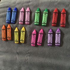 crayons are lined up on a blanket and laid out in the shape of candy