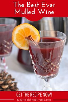 two glasses filled with mulled wine on top of a table