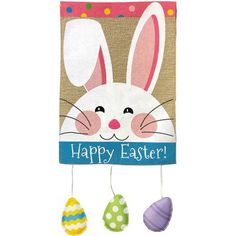 a happy easter banner hanging on a clothes line with three eggs in front of it