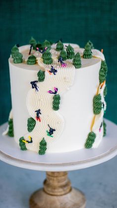 a white cake with green decorations on it