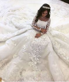 a woman in a white wedding dress laying on the floor with her hand on her hip