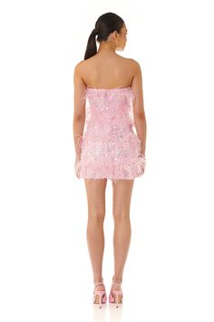 The Tiffany Dress designed in embellished sequin features a shaped neckline and figure hugging mini silhouette. Complimented with rows of pink ostrich feathers and complete with lining and a center back exposed zipper closure. The Tiffany Dress is a fun and alluring party piece perfect the summer season. Model is 5'9" and is wearing a size XSMALL Fabric: Main 1 : 100% Real Ostrich Feather, Main 2: 50% Polyester 50% PET Fully Lined Gentle Hand Wash Recommended Please refer to product images for m Mini Sequin Dress, Tiffany Dress, Feather Mini Dress, Tiffany Dresses, Dazzling Dress, Feather Stitch, Off Shoulder Dresses, Sequin Design, Pink Bodycon Dresses