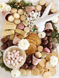 a platter filled with lots of different types of cookies and desserts on top of each other