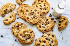 chocolate chip cookies and milk on a marble surface