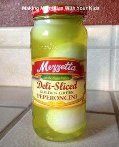 a jar of mayonnaise sitting on top of a kitchen counter next to a tile wall