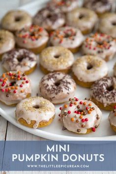 a plate full of mini pumpkin donuts with sprinkles