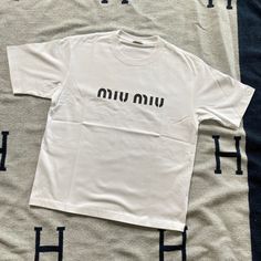 White T-Shirt With Black Logo On The Front. Slightly Oversized Fit. Worn Once And Dry Cleaned. No Flaws. Casual Miu Miu Short Sleeve Tops, Casual Miu Miu Tops For Spring, Miu Miu T Shirt, Miu Miu Shirt, Beauty Clothes, Logo Color, Black Logo, Fashion Killa, White T Shirt