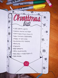 a christmas list with markers and crayons next to it