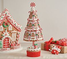 gingerbread houses and christmas gifts on a table