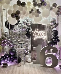 a room filled with balloons and decorations for a 65th birthday