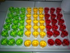 an assortment of colored cups sitting on top of a counter