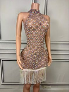 Elegant Design: Features a high halter neckline with intricate beadwork in a mesmerizing pattern. Sheer Illusion Fabric: The bodice is crafted with sheer mesh, adorned with sparkling beads for a sophisticated look. Fringe Hemline: Accented with a playful fringe hem, adding movement and flair to the dress. Bodycon Fit: Tailored to hug your curves and enhance your silhouette for a flattering appearance. Perfect for Special Occasions: Ideal for parties, evening events, and glamorous nights out. Com Glamorous Net Dress With Sequins, Party Dress With Sequins On Net Material, Fitted Sequin Dress With Net Material, Party Dress With Sequins On Net, Sequin Net Party Dress, Fitted Sequin Net Dress, Glamorous Fitted Net Dress, Sequin Net Dress For Party, Fitted Sequin Dresses In Net Material