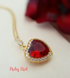 "This red heart necklace is made with your choice of a 20mm bright siam/ruby red or dark garnet red crystal heart pendant which is surrounded by sparkly clear CZs and dangles below a CZ bail on a lovely gold-plated cable chain. This necklace is 18 inches long. Thank you for looking. - Shop Gemsicles, an Etsy boutique with hundreds of sparkly items for weddings, gifts and just because. Our original jewelry designs feature gemstones, Swarovski® crystals, pearls, CZs, vintage components, porcelain Crystal Valentine, Jewelry Giveaway, Red Heart Necklace, Necklace Ruby, Garnet Heart, Original Jewelry Design, Romantic Gifts For Her, Crystal Heart Pendant, Heart Red