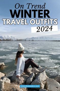 a woman sitting on rocks near the water with text overlay that reads, on trend winter travel outfits 2012