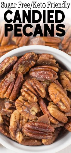 a white bowl filled with candied pecans on top of a table