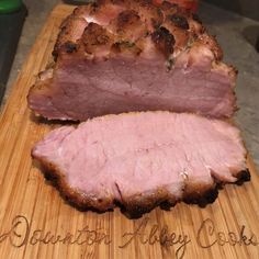 a large piece of meat sitting on top of a wooden cutting board