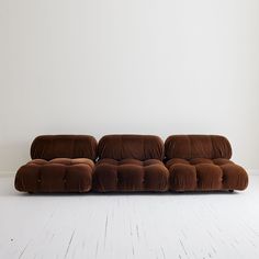 a brown couch sitting on top of a white floor