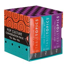 three books in a box with an orange, blue and purple design on the cover