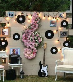 there is a guitar and some flowers on the wall