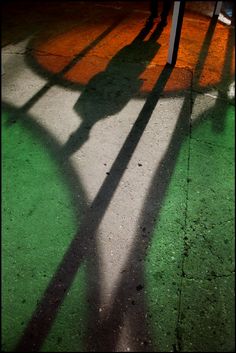 the shadow of a person holding a frisbee