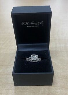 a diamond ring in a black box on a table