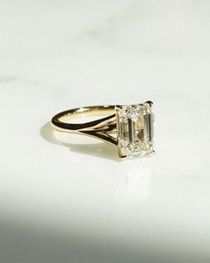 a diamond ring sitting on top of a white table