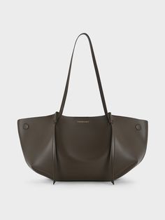 In a deep and rich dark moss, this Calla tote bag is a worthy contender to classic black bags -- exuding elegance and class, and is equally as timeless. The softly structured geometric silhouette with artfully sculpted folds makes it beautiful to behold from every angle. Along with its capacious interior, this bag will hold everything you need and more. It also comes with a detachable pouch to keep your belongings organised and easily accessible. Timeless Bags With Removable Pouch For Shopping, Timeless Bag With Removable Pouch For Shopping, Classic Hobo Bag With Handle Drop For Office, Timeless Double Handle Shoulder Bag For Shopping, Timeless Large Capacity Formal Bag, Timeless Large Capacity Tote Shoulder Bag, Timeless Brown Shoulder Bag For Shopping, Office Shoulder Bag With Double Handle And Dust Bag, Classic Hobo Bag For Shopping