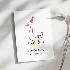 a birthday card with a white duck wearing a party hat and the words happy birthday silly goose