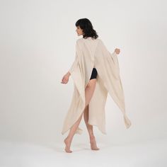 Step up your beach attire with our Elaine Linen Kimono & Beach Cover-Up. Crafted from linen, it's perfect for relaxing or taking a stroll along the shore. The versatile beige color complements any outfit, while the loose fit accommodates most body types.Featuring a stylish V-neck design, long sleeves, and pockets on each side, this kimono offers both style and practicality. With its easy button closure, it's a breeze to slip on over your swimsuit for quick coverage. Whether you're lounging by th Beachwear Cover-up Wrap For Loungewear, Beachwear Wrap Cover-up, Long Beach Season Cover-up For Loungewear, Linen Beachwear Cover-up For Spring, Beachwear Linen Cover-up For Vacation, Linen Beach Cover-up, Linen Beach Cover-up For Beach Season, Bohemian Linen Cover-up For Vacation, Summer White Kimono For Relaxation