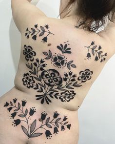 a woman with tattoos on her stomach and back