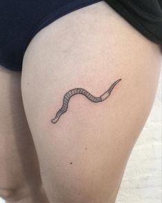 a woman's thigh with a tattoo of a snake on the lower half of her leg