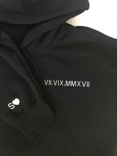 This listing is for ONE custom embroidered UNISEX hoodie. Please add twice to cart for two hoodies. The date is on the left chest and the initial and heart is on the right sleeve. If you would like different placements for these designs please message us on Etsy. The more text you add the smaller the text will be. If you do not write what thread color you would like in the personalization box we will use a thread color that compliments the hoodie color. Interested in a different hoodie and/or thread color? Message us on Etsy to request a color. Please see the size chart in the product listing photos to determine the best size for you. This custom embroidered hoodie makes a great couples gift for many occasions and holidays - anniversary, engagement announcement, bachelorette gift, wedding, Winter Black Hoodie With Embroidered Text, Casual Black Hoodie With Embroidered Text, Black Crew Neck Hoodie With Embroidered Text, Streetwear Hoodie With Embroidered Text, Sporty Hooded Hoodie With Custom Embroidery, Hooded Hoodie With Embroidered Text For Streetwear, Heart On Sleeve, Anniversary Gift For Him, Engagement Announcement