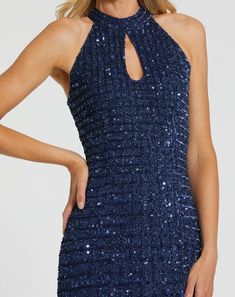 a woman is wearing a blue dress with sequins on the neck and back