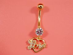 Brand new real solid 14k yellow dangling heart love belly button ring 5m stone center aaa cubic zirconia shiny stone high polish great finish luxury attractive look high quality screw on and off guarantee real 14k gold mark and stamp on the banana bar and the top srcew come in nice gift box make it perfect gift for any occasion Dainty Gold Belly Rings For Wedding, Gold Heart-shaped Elegant Piercings, Elegant Gold Heart-shaped Piercings, Elegant Gold Heart Piercings, Gold Heart-shaped Body Jewelry As Gift, Elegant Heart-shaped Wedding Belly Rings, Gold Heart Pendant Jewelry With Bling, Gold Cubic Zirconia Body Jewelry For Gifts, Gold Bling Heart Pendant Jewelry