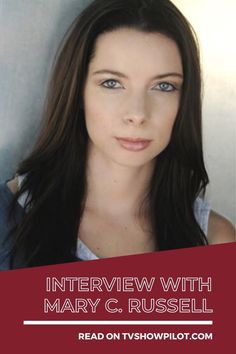 a woman with long hair and blue eyes is looking at the camera while she's interviewed