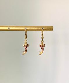 Experience the elegance of aquatic beauty with our Unique Koi Fish Earrings. These earrings encapsulate the grace and serenity of koi fish in a truly captivating design. Meticulously crafted, the mini koi fish charms radiate intricate detail and symbolism. The lightweight huggie style offers a comfortable fit, perfect for all-day wear. Whether you admire the symbolism of koi fish or seek a distinctive accessory, these earrings make a statement. Ideal for both casual outings and special occasions Koi Fish Earring, Koi Fish Earrings, Koi Fish Jewelry, Gold Fish Jewelry, Koi Earrings, Orange Koi, Fish Earrings, Fish Jewelry, Moon Studs