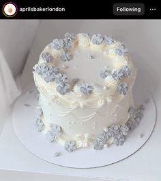 a white frosted cake with flowers on it