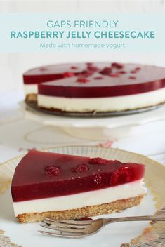 a piece of raspberry jelly cheesecake on a plate with a fork next to it