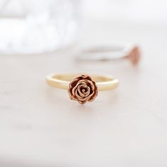 "A beautiful floral ring that is meant to inspire you to be your true authentic self! To \"Be A Rose\" and realize your own beauty and magic lies within you! Rose Gold flower set on a gold or silver band.  - - - D E T A I L S - - -  * Made of 925 Sterling Silver * We use a THICK plating of 14k Gold, Rose Gold & Rhodium  * Available in sizes 4-10 * Flower measures:  * Nickel-free & Hypoallergenic  ♥︎ ♥︎ Rings on Model ♥︎ ♥︎ Rope Ring https://www.etsy.com/listing/1455918079/dainty-ring-minimalist-ring-stacking?click_key=a0661a1e336bfa6b62d7f7b79303f6a4ed1b62dc%3A1455918079&click_sum=0665026d&ga_search_query=rope%2Bring&ref=shop_items_search_3&pro=1&frs=1&sts=1 Plain Band  https://www.etsy.com/listing/1577071963/dainty-ring-minimalist-ring-stacking Diamond Stacking Ring https://www.etsy.com/l Gold Flower Ring For Valentine's Day, Rose Gold Flower Shaped Rings For Gift, Rose Gold Flower Ring With Rose Design, Rose Design Promise Jewelry, Valentine's Day Gold Flower Ring, Rose Gold Flower Ring For Gift, Promise Ring With Rose Design, Rose Gold Flower Proposal Ring, Rose Design Flower Promise Ring