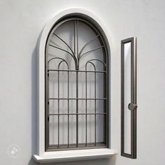 an arched window on the side of a white wall