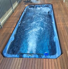 an inflatable hot tub sitting on top of a wooden deck