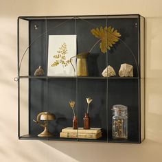 a shelf filled with books and vases on top of it