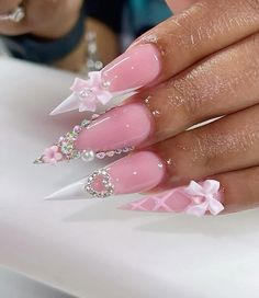 @AngieDiors Girly Nails Aesthetic, Nail Ideas Blinged Out, Pink And White Nails With Charms, Birthday Nails Coffin Pink, White Pink Gold Nails, Pink Gemini Nails, Pink And White Bow Nails, Stiletto Junk Nails, Pink French Tip With Gems