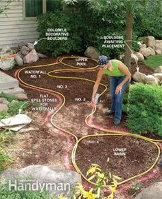 a woman is working on landscaping in her yard